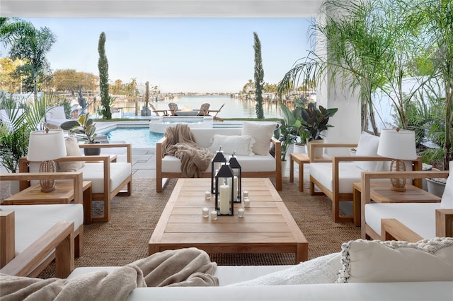 view of patio / terrace featuring an outdoor hangout area, a fenced in pool, and a water view