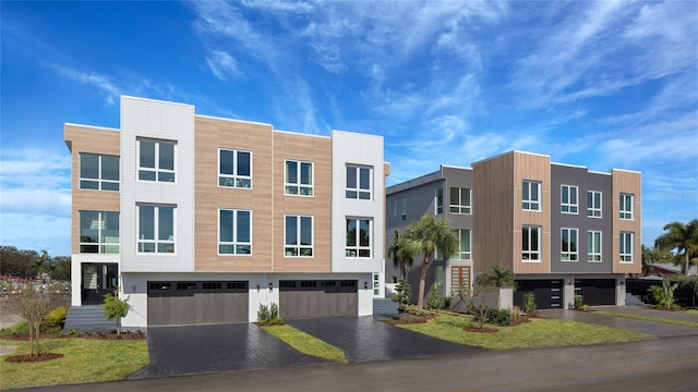 view of building exterior featuring driveway and an attached garage