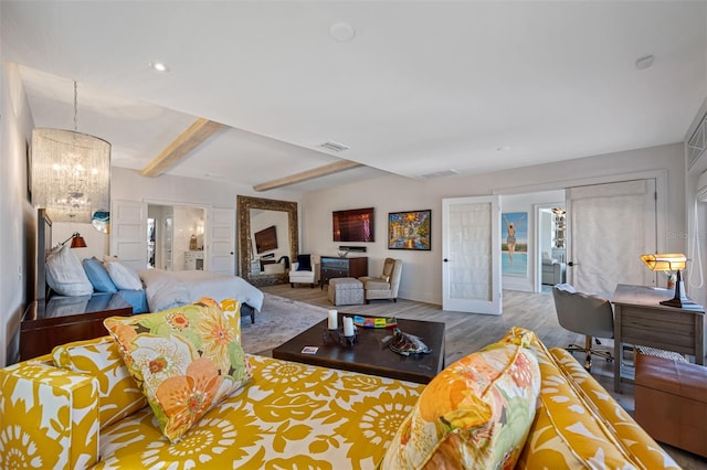 living room with beamed ceiling, french doors, an inviting chandelier, and light hardwood / wood-style flooring