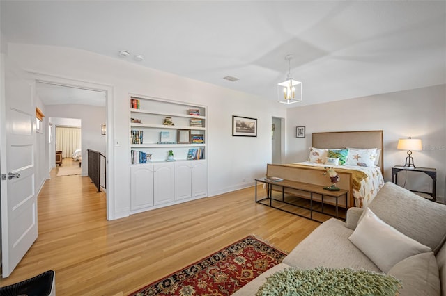 bedroom featuring lofted ceiling and light wood-type flooring