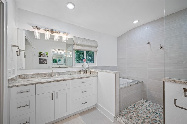 bathroom with vanity and independent shower and bath