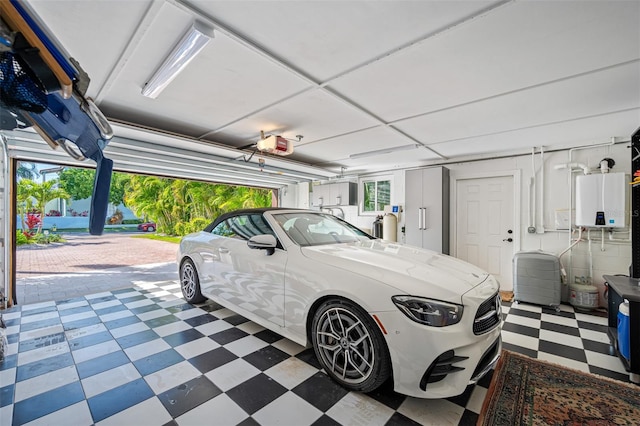 garage with water heater and a garage door opener