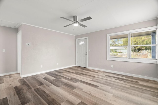 spare room featuring crown molding, light hardwood / wood-style flooring, and ceiling fan