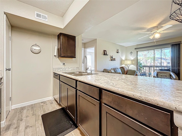 kitchen with sink, light hardwood / wood-style flooring, dishwasher, ceiling fan, and dark brown cabinetry