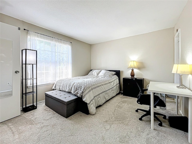 carpeted bedroom with a textured ceiling