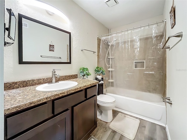 full bathroom with shower / tub combo with curtain, vanity, and toilet