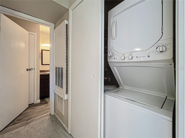 laundry area featuring stacked washer and dryer