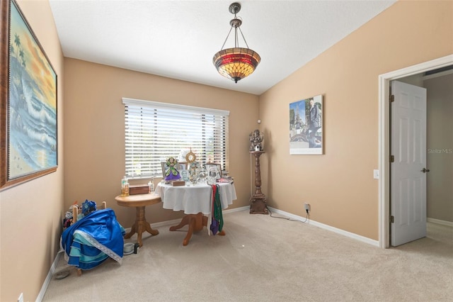 misc room with light colored carpet and vaulted ceiling