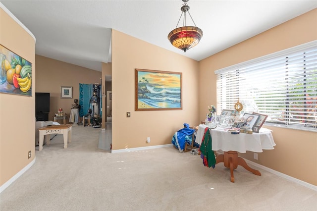 interior space with light carpet and vaulted ceiling