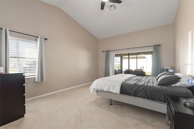 bedroom with multiple windows, light colored carpet, vaulted ceiling, and ceiling fan