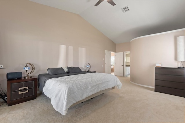 bedroom featuring ensuite bath, ceiling fan, light colored carpet, and vaulted ceiling