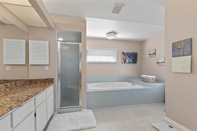 bathroom featuring tile patterned flooring, shower with separate bathtub, vanity, and a textured ceiling