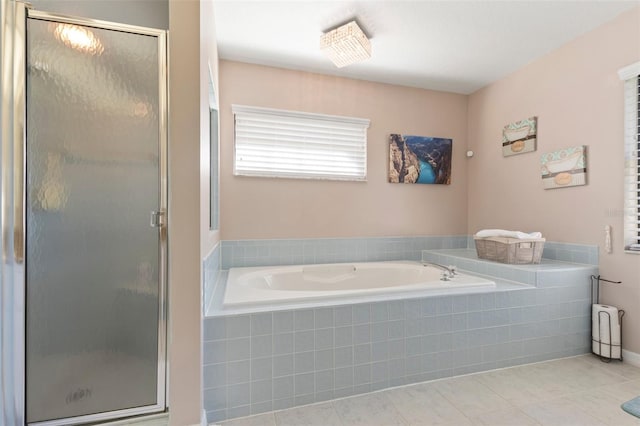 bathroom with separate shower and tub and tile patterned floors