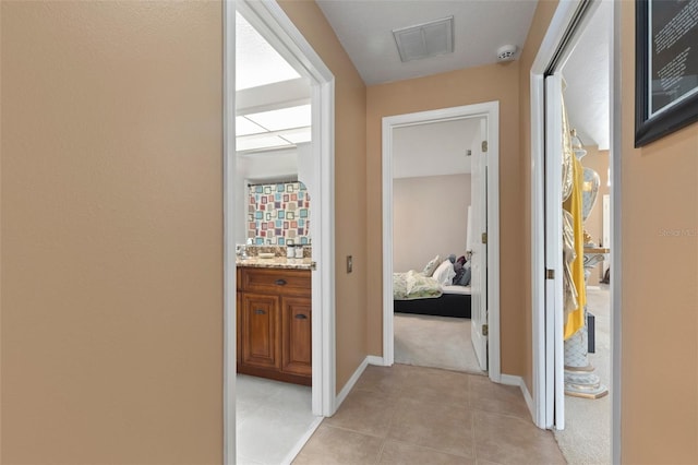 corridor with light tile patterned floors