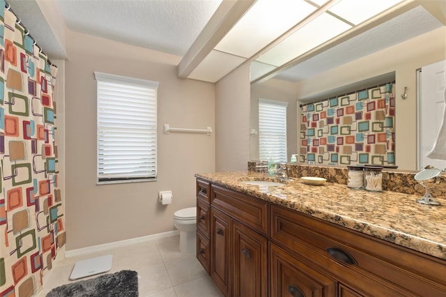 bathroom with tile patterned floors, vanity, toilet, and a textured ceiling