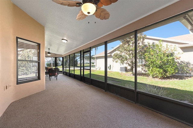 unfurnished sunroom featuring ceiling fan and vaulted ceiling