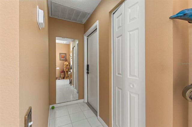 corridor with light tile patterned floors