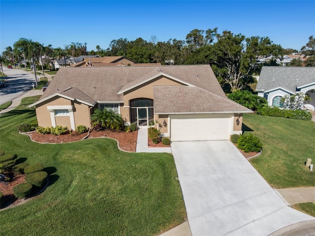 ranch-style house featuring a front lawn and a garage