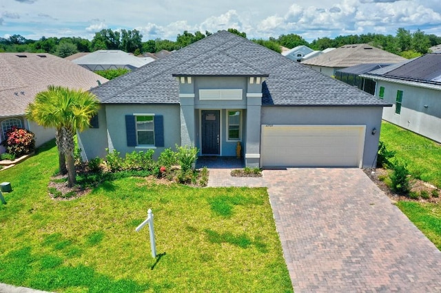 view of front of home with a front yard and a garage