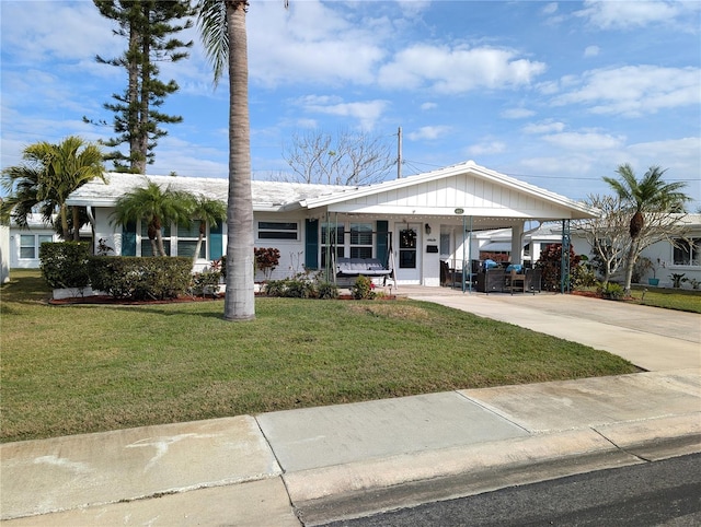 single story home with a carport and a front lawn