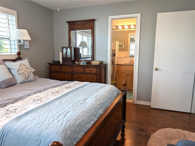 bedroom featuring multiple windows, a textured ceiling, dark hardwood / wood-style flooring, and ensuite bath