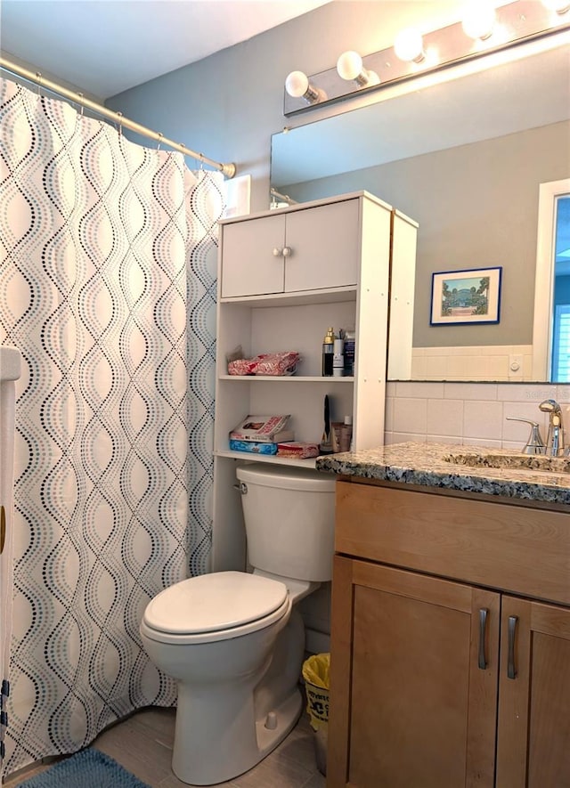 bathroom featuring vanity, toilet, and a shower with shower curtain