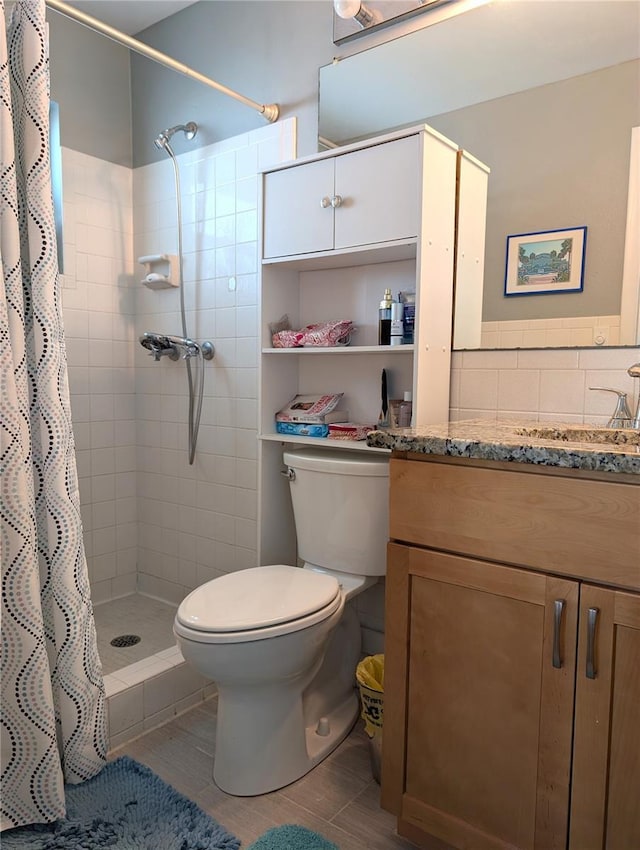 bathroom with walk in shower, tile patterned floors, vanity, and toilet