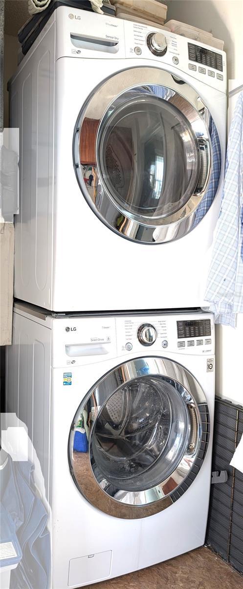 laundry area featuring stacked washer / dryer