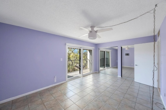 tiled empty room featuring ceiling fan and a textured ceiling