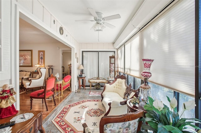 sunroom / solarium featuring ceiling fan