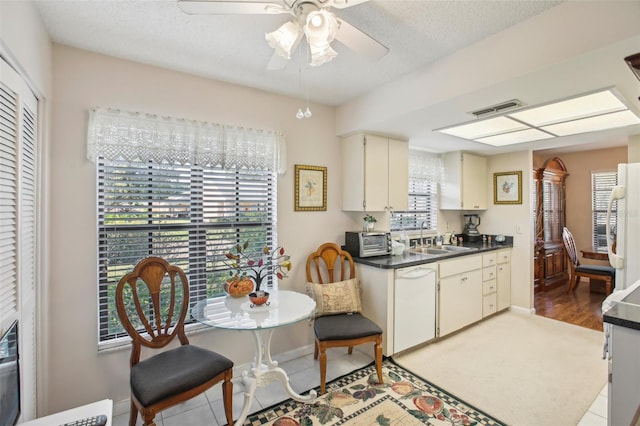 kitchen with white appliances, sink, ceiling fan, a textured ceiling, and light hardwood / wood-style floors