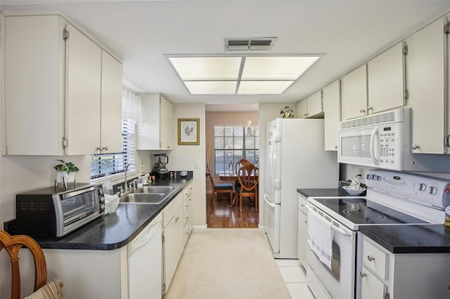 kitchen featuring white cabinets, white appliances, light hardwood / wood-style floors, and sink