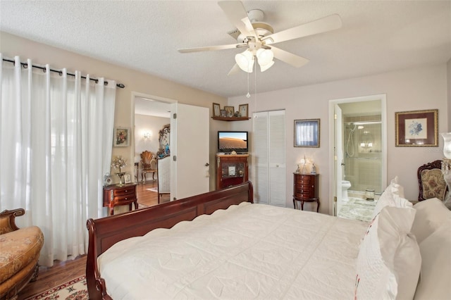 bedroom featuring ensuite bath, ceiling fan, a textured ceiling, a closet, and hardwood / wood-style flooring