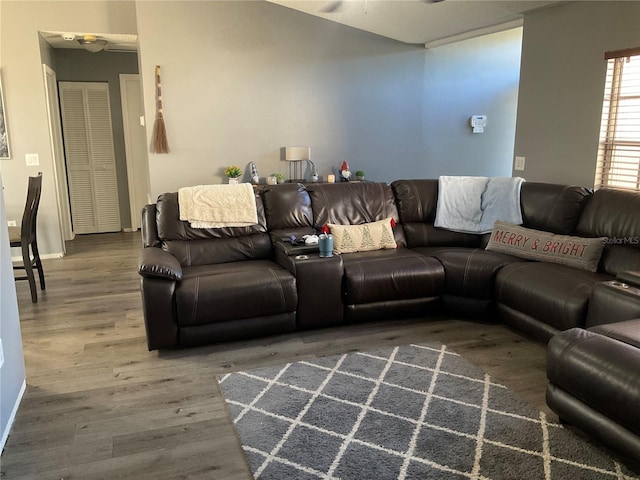 living room with wood-type flooring and ceiling fan