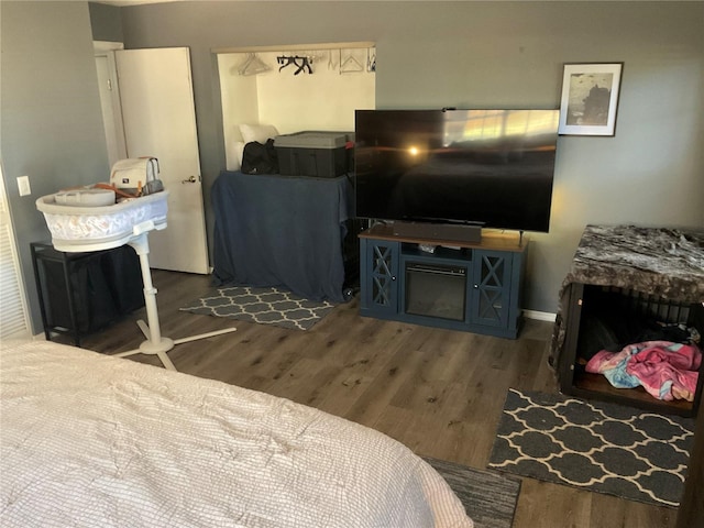 bedroom with dark hardwood / wood-style floors