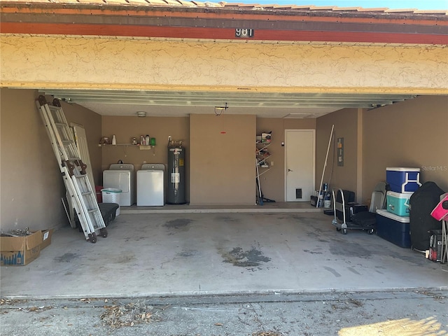 garage featuring washer and clothes dryer and water heater