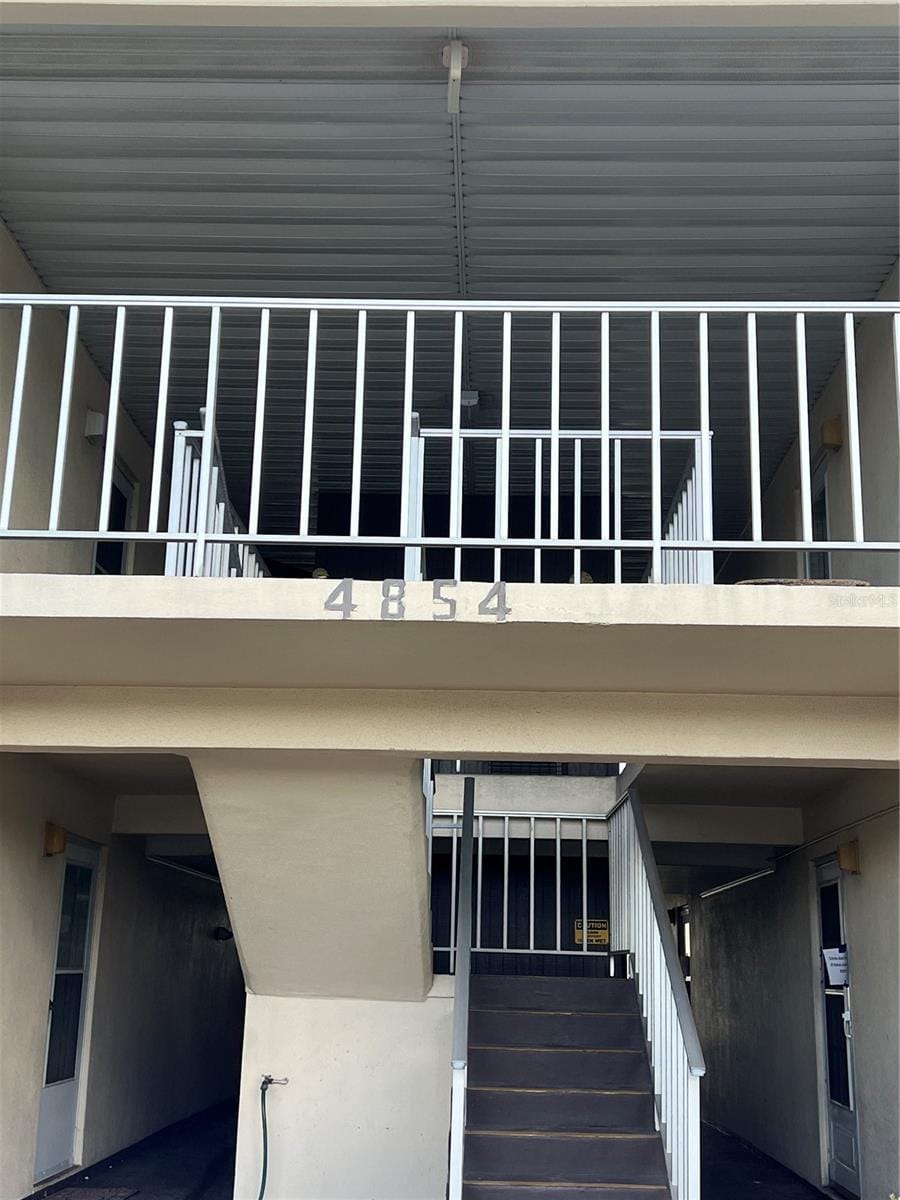 4854 Marine Pkwy Unit 101, New Port Richey, FL 34652 - view of home's exterior featuring a balcony and stucco siding