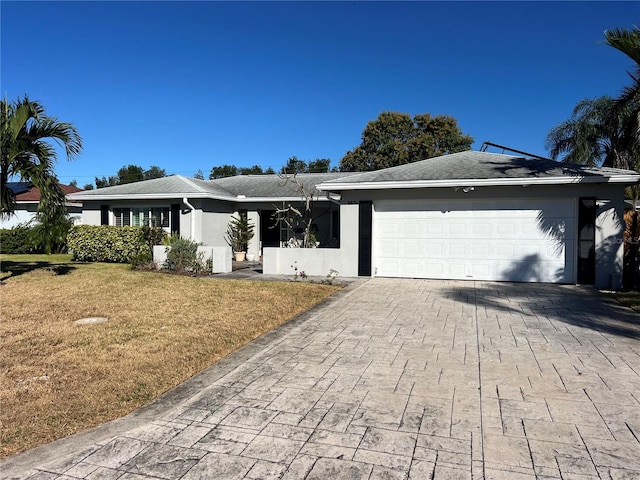 single story home featuring a front yard and a garage