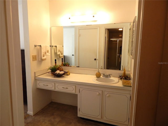 bathroom with a shower with door and vanity