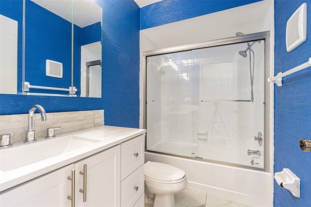 full bathroom featuring toilet, backsplash, a textured ceiling, vanity, and shower / bath combination with glass door