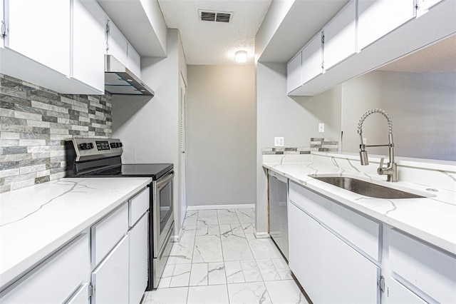 kitchen featuring white cabinets, appliances with stainless steel finishes, sink, and a textured ceiling