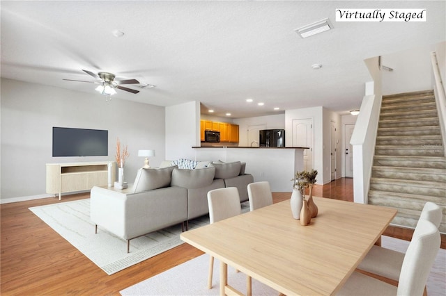 dining space featuring ceiling fan, light hardwood / wood-style floors, and a textured ceiling