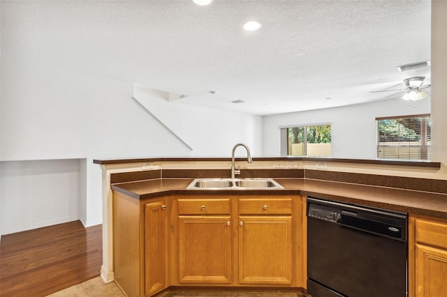 kitchen with dishwasher, light hardwood / wood-style flooring, a textured ceiling, and sink