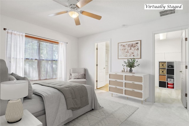 carpeted bedroom with ceiling fan and ensuite bathroom