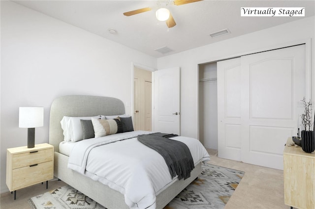 bedroom featuring light carpet, a closet, and ceiling fan