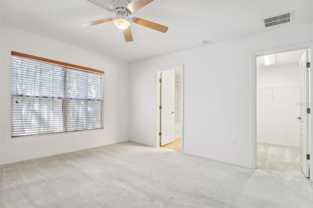 spare room with light carpet and ceiling fan