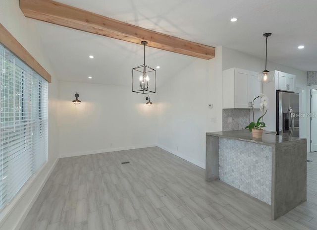 unfurnished living room with vaulted ceiling with beams, light wood-type flooring, and an inviting chandelier