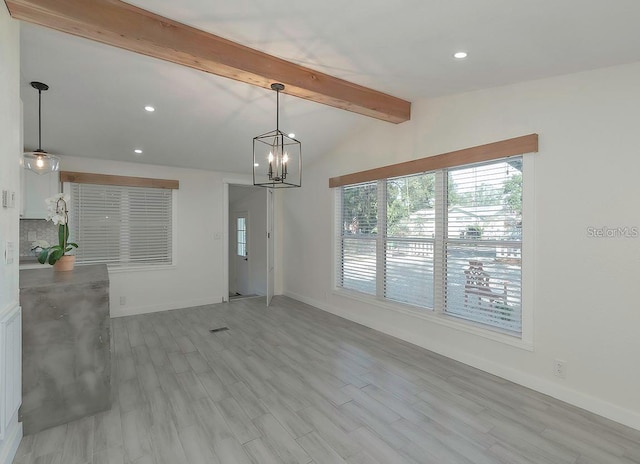 interior space with vaulted ceiling with beams, light hardwood / wood-style flooring, and a notable chandelier