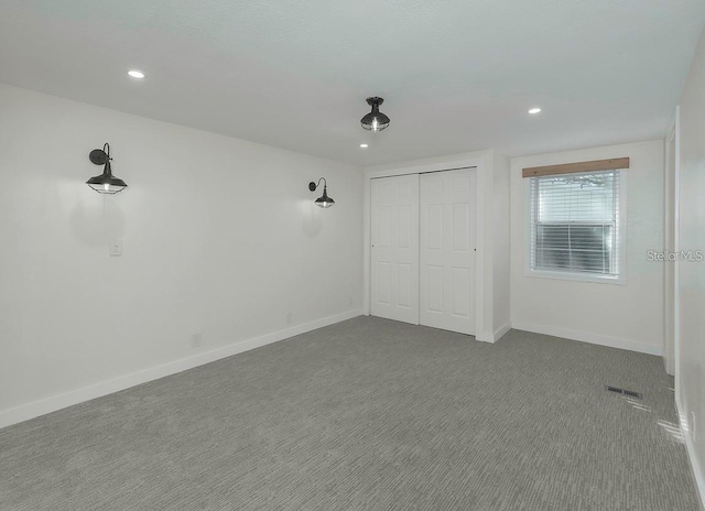 unfurnished bedroom featuring carpet and a closet