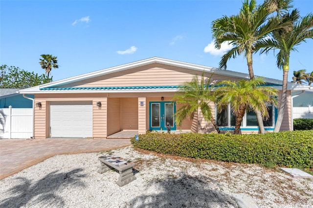 view of front of property featuring french doors and a garage